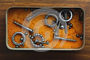 Broken bearings and screws in a box photo