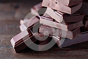 Broken black chocolate pieces.