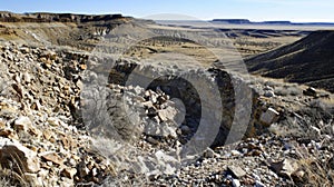 Broken boulders and rubble strewn about the rim of a crater evidence of the intense impact that shook the earth