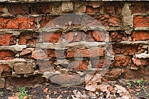 broken brick wall Background. red brick wall collapses from old age