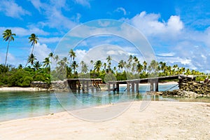 Broken bridge under palm trees between islets over lagoon, North Tarawa atoll, Kiribati, Micronesia, Gilbert islands, Oceania,