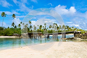 Broken bridge under palm trees between islets over lagoon, North Tarawa atoll, Kiribati, Micronesia, Gilbert islands, Oceania, photo