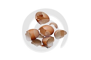 Broken brown chicken egg shells scattered on a white background
