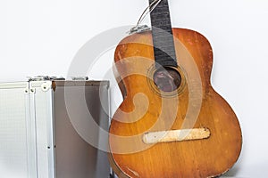 Broken brown classical guitar with detached bridge from body in white background