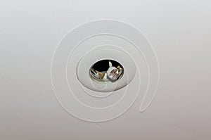 Broken, burnt out LED light bulb flickering on the ceiling