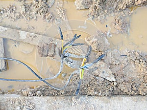 broken cable connection on muddy ground