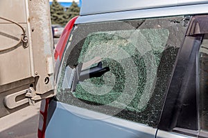 Broken car glass in an accident. Damaged automotive glass background pattern. Broken car as a result of a road accident