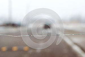 Broken car glass with crack on windshield of auto