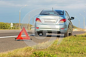 Broken car with red triangle sign.