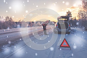 Broken car on a snowy winter road