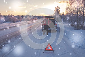 Broken car on a snowy winter road