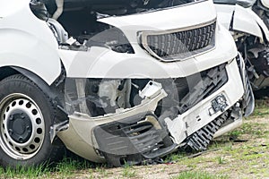 Broken car white van after frontal collision. Closeup