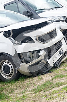 Broken car white van after frontal collision. Closeup