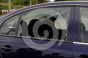 Broken car window and cracked glass of a automobile
