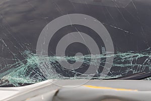 Broken car windshield .Crash windshield glass the broken and damaged car. Tempered glass shattered in an accident. Broken Windshie