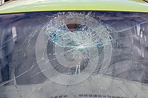 Broken car windshield. Hole in car glass