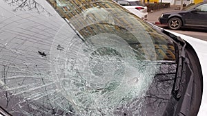 Broken car windshield after a road accident