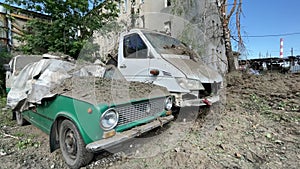 Broken cars covered with earth after shelling. The real war between Ukraine and Russia