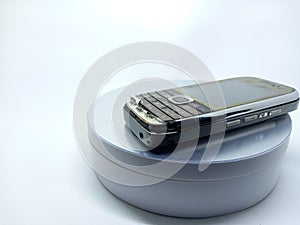 broken cellphone keypad on old cellphone on white background on turntable