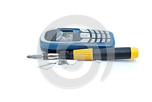 Broken cellular phone and screwdriver