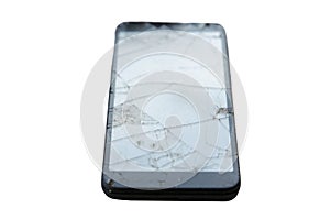 Broken Cellular Telephone. A Cellular Telephone with a cracked and broken Screen on a white plate on a table. Broken Cell Phone