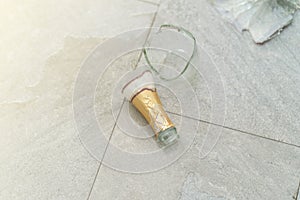 Broken champagne bottle on the floor