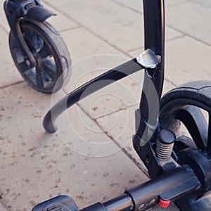 Broken chassis of a baby stroller, damage to the crossbar of the metal frame of the pram