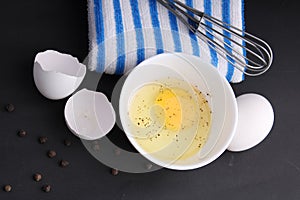 Broken chicken egg with shell and seasoning.