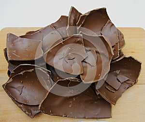 Broken chocolate Easter egg on a wooden table