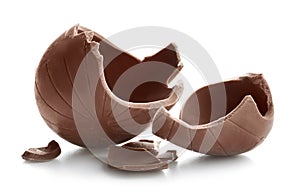 Broken chocolate Easter egg on white background
