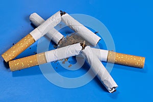 broken cigarettes with scattered tobacco, quit smoking concept