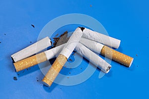 broken cigarettes with scattered tobacco, quit smoking concept