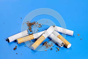 broken cigarettes with scattered tobacco, quit smoking concept