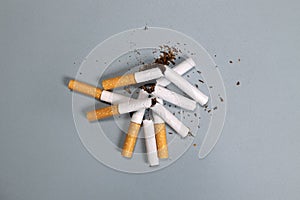 broken cigarettes with scattered tobacco, quit smoking concept