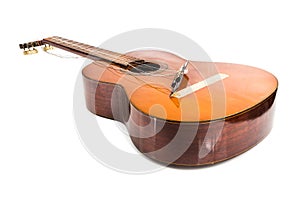 Broken classical guitar with detached bridge isolated in white b