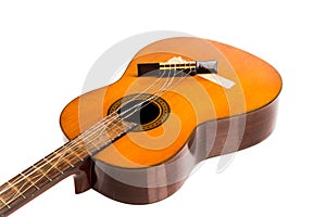 Broken classical guitar with detached bridge isolated in white b