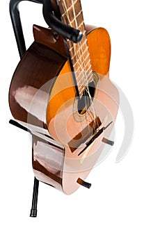 Broken classical guitar with detached bridge isolated in white b