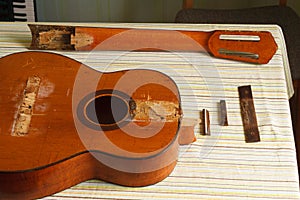 Broken classical guitar on a table
