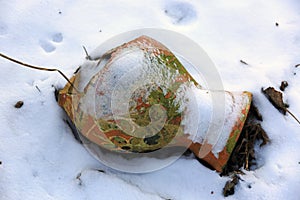 Broken clay jug in the snow