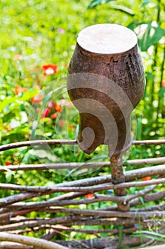 Broken clay pot close up at wattle fence