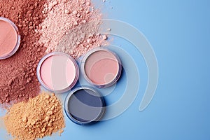 A broken colored make up palette, powder blush and powder