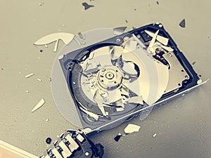 Broken computer hard disk on a table - complete data destruction.