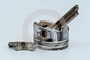 Broken connecting rod and engine piston isolated on white background