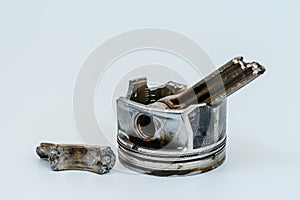 Broken connecting rod and engine piston isolated on white background