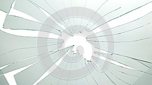 Broken and cracked glass with hole on a white background