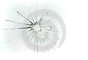 Broken and cracked glass with hole on a white background