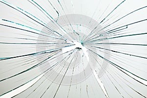 Broken and cracked glass with hole on a white background