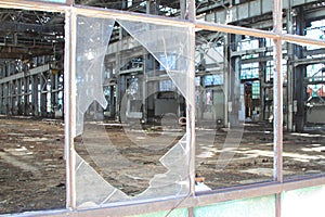 Broken and cracked industrial windows in metal frames