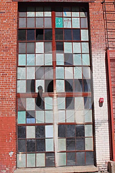 Broken and cracked industrial windows in metal frames photo