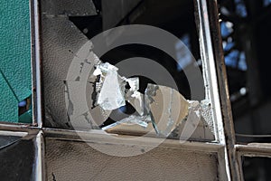 Broken and cracked industrial windows in metal frames photo